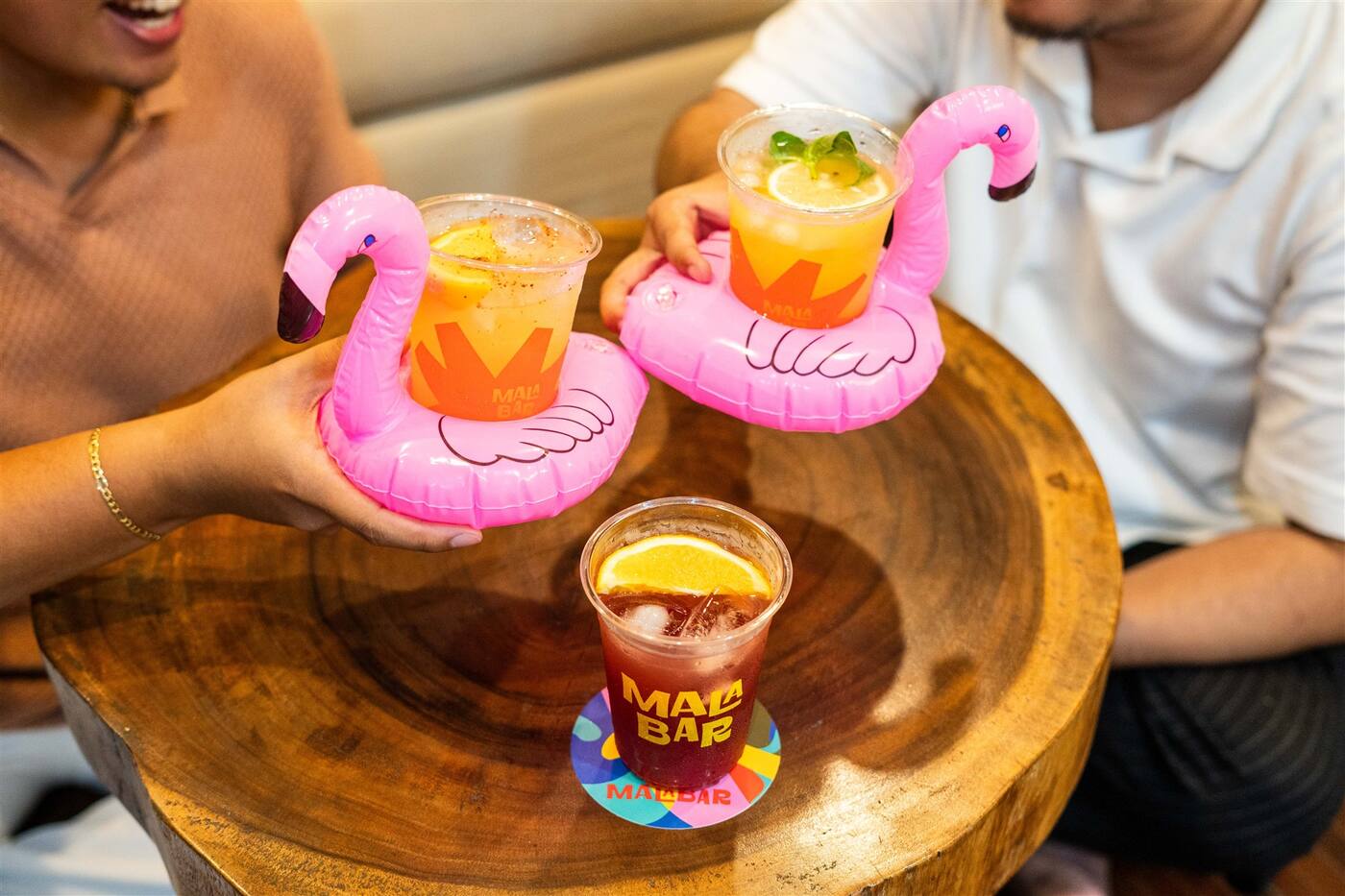 Iced drinks riding flamingo floaties at a party